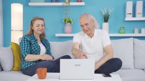 Couple-watching-comedy-movie-on-laptop.-They-are-having-fun.
